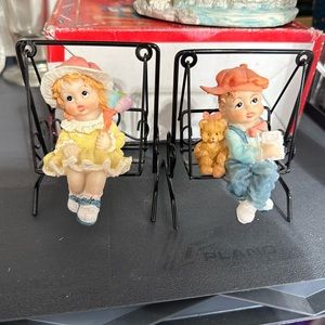 Figurines Boy with bear & Girl with balloons sitting on swings that swing